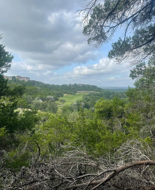 Hill Country terrain and golf course view from a River Place trail